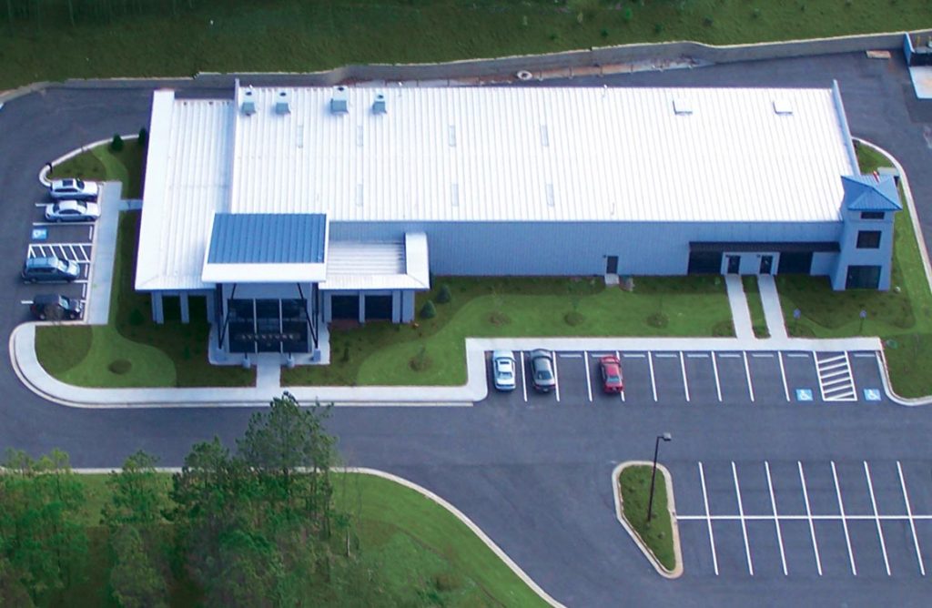 A birdseye view of Aventure Aviation's main facility in Peachtree City, Georgia, USA, surrounded by green landscaping and parking lots