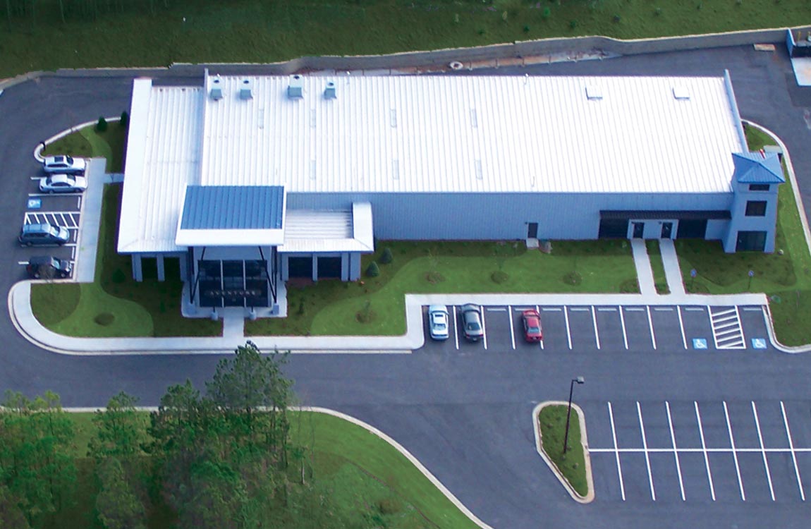 A birdseye view of Aventure Aviation's main facility in Peachtree City, Georgia, USA, surrounded by green landscaping and parking lots