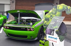 A green Dodge Challenger TA next to a cardboard cutout of the Hulk