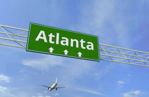 Atlanta highway sign, with airplane in the sky landing