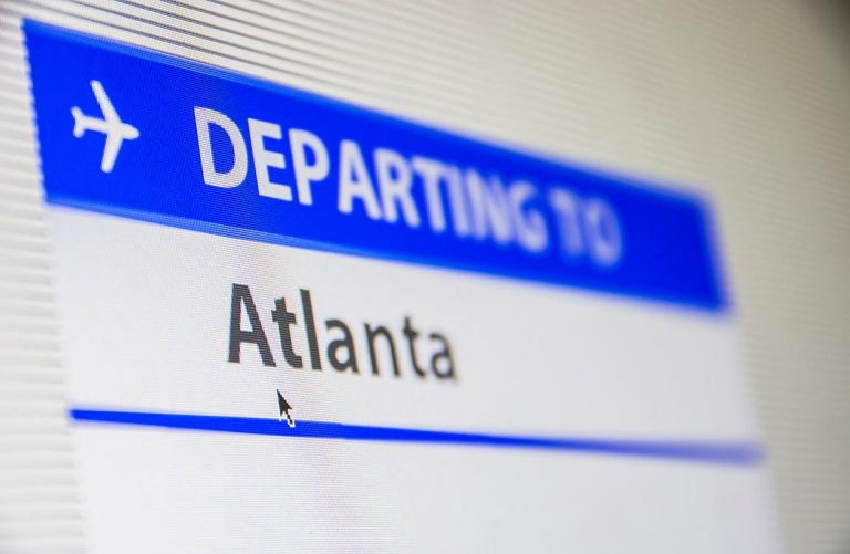 "Departing to Atlanta" text on computer screen