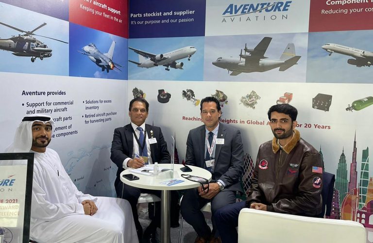 Aventure Aviation staff meet with a guest at their 2021 Dubai Airshow stand.