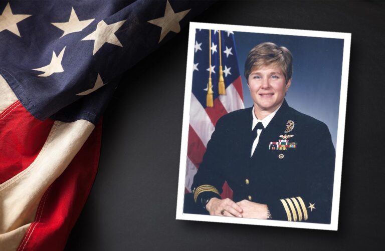 Portrait of a female U.S. Navy Captain, Jane Skiles O'Dea, in front of an American flag