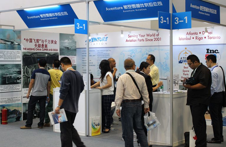 People in front of Aventure Aviation's booth at Aviation Expo/China 2015.